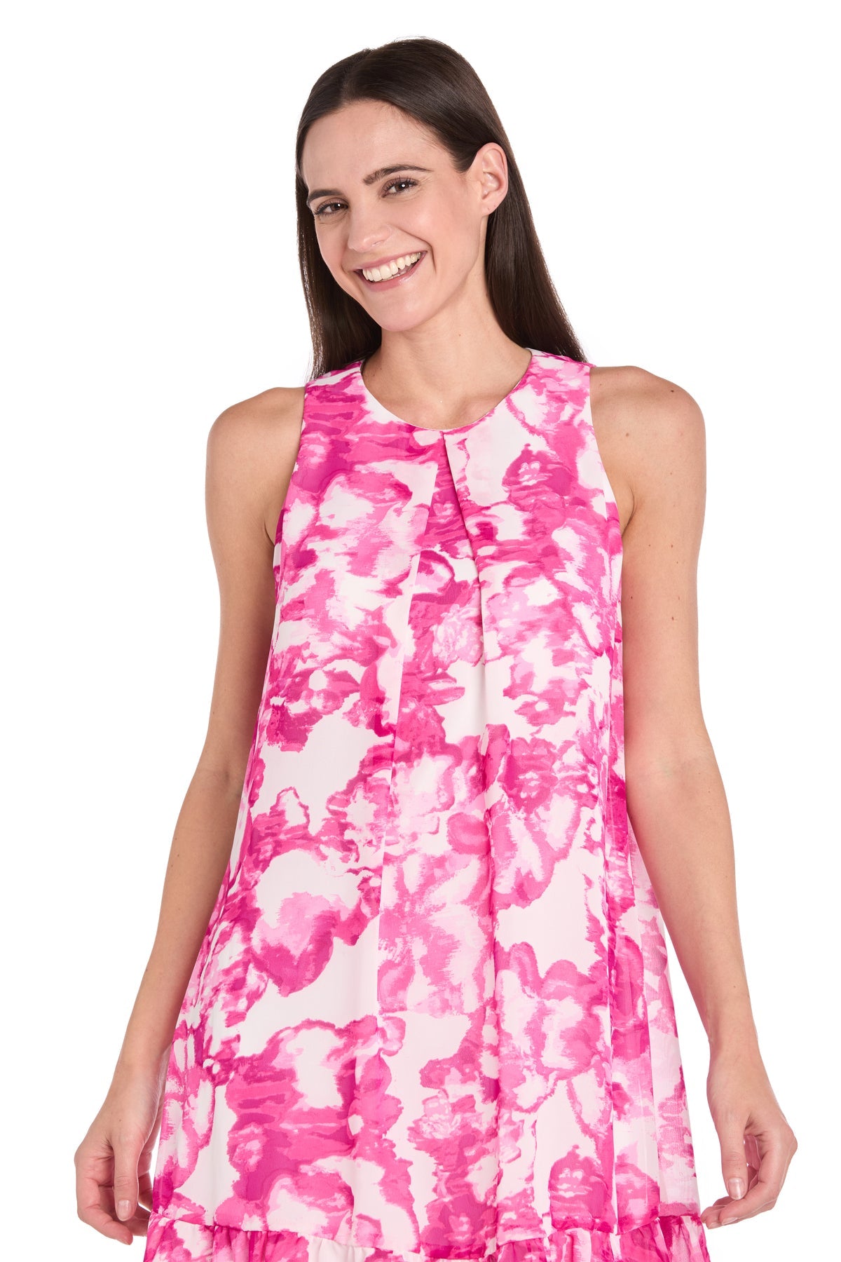 A woman smiles while wearing the R&M Richards 6655 Pink Print Short Party Dress, featuring a sleeveless floral design, set against a plain white background.